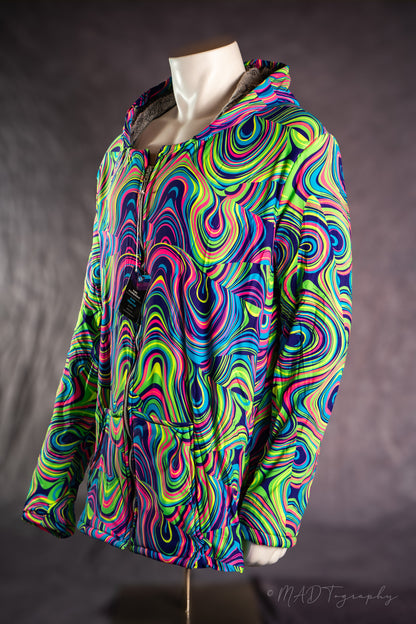 Colorful fluorescent psychedelic patterned jacket on a mannequin against a dark background