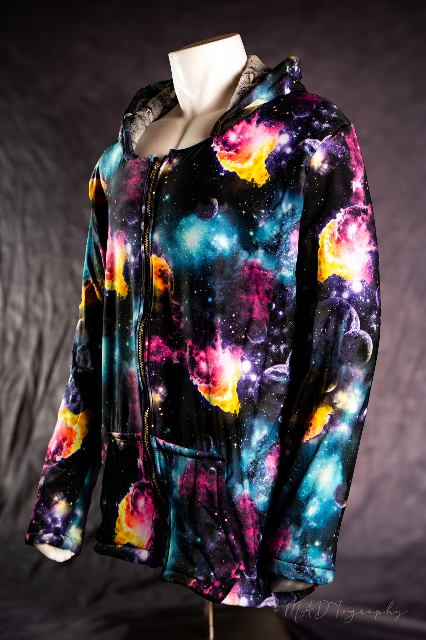 Colorful galaxy-themed hoodie on a mannequin against a dark background